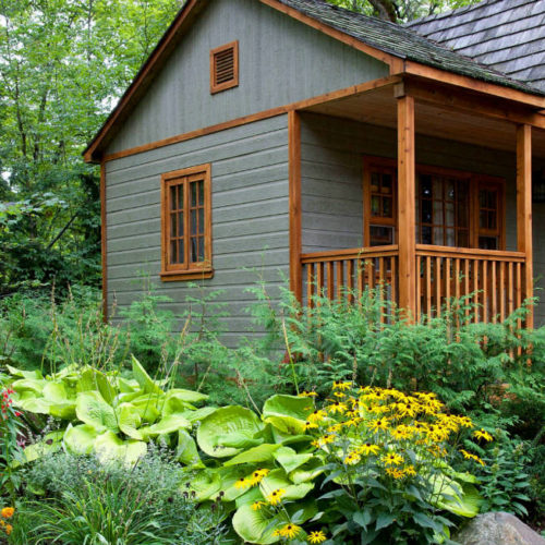 A cute, green cottage unit in a lush Seattle backyard
